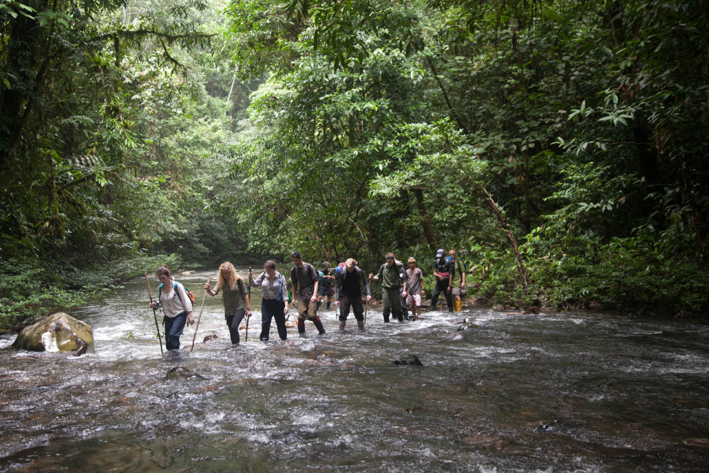 Students from the 2015 field trip crossing a river en route to their camp.